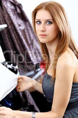 Young woman inside a store buying clothes Young woman inside a store buying clothes