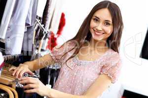 Young woman inside a store buying clothes