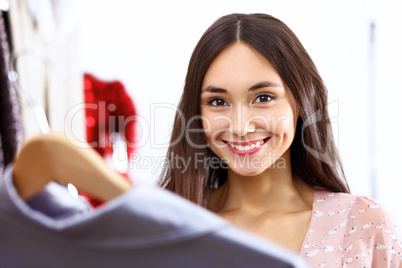 Young woman inside a store buying clothes