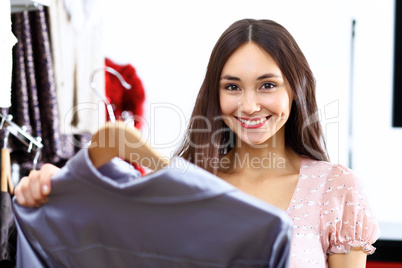 Young woman inside a store buying clothes