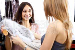 Young woman inside a store buying clothes