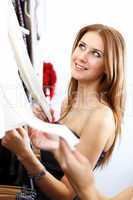 Young woman inside a store buying clothes