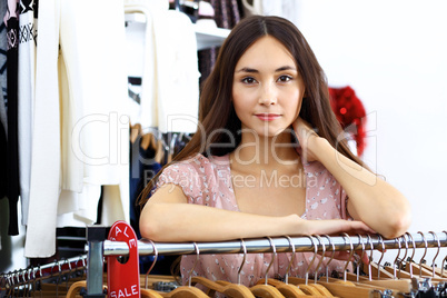 Young woman inside a store buying clothes