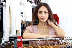 Young woman inside a store buying clothes