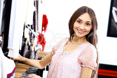 Young woman inside a store buying clothes