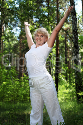 An elderly woman practices yoga