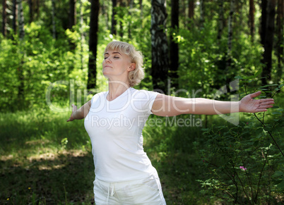 An elderly woman practices yoga