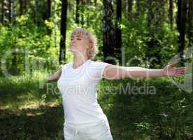 An elderly woman practices yoga