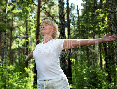 An elderly woman practices yoga