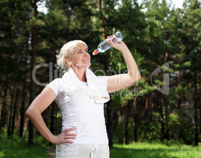 elderly woman after exercising in the forest