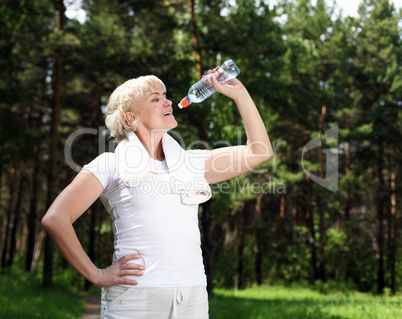 elderly woman after exercising in the forest