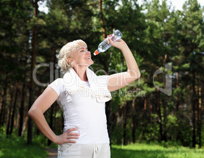 elderly woman after exercising in the forest