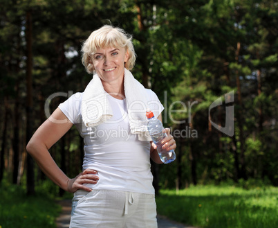 elderly woman after exercising in the forest