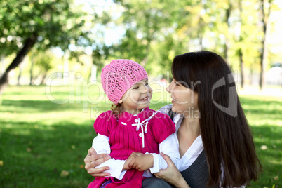 Mother with her daughter in summer park