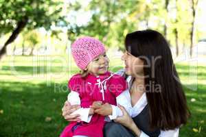 Mother with her daughter in summer park