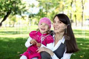 Mother with her daughter in summer park