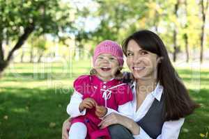 Mother with her daughter in summer park