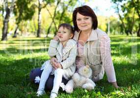 Grandmother with her little granddaghter in park