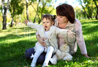 Grandmother with her little granddaghter in park