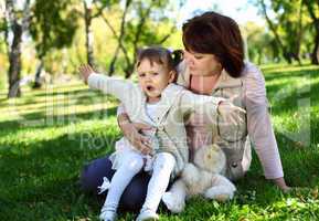 Grandmother with her little granddaghter in park