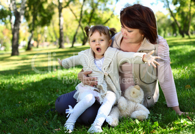 Grandmother with her little granddaghter in park