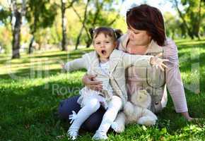 Grandmother with her little granddaghter in park