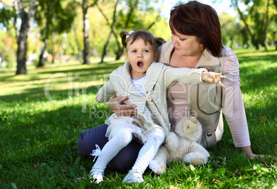 Grandmother with her little granddaghter in park