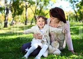 Grandmother with her little granddaghter in park