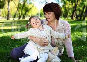 Grandmother with her little granddaghter in park