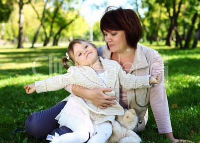 Grandmother with her little granddaghter in park