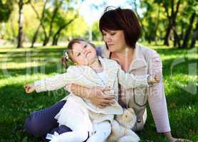 Grandmother with her little granddaghter in park