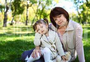 Grandmother with her little granddaghter in park