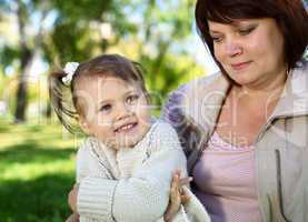 Grandmother with her little granddaghter in park