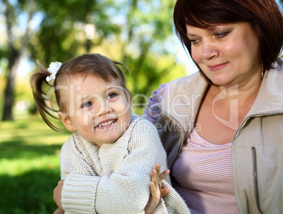 Grandmother with her little granddaghter in park