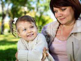 Grandmother with her little granddaghter in park