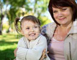 Grandmother with her little granddaghter in park