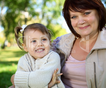 Grandmother with her little granddaghter in park