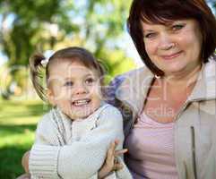 Grandmother with her little granddaghter in park