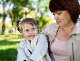 Grandmother with her little granddaghter in park