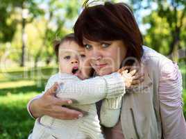 Grandmother with her little granddaghter in park