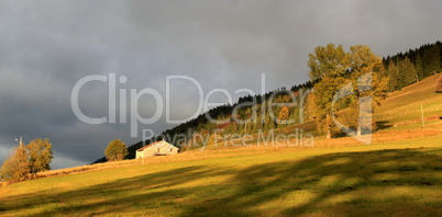 Landscape by autumn sunset