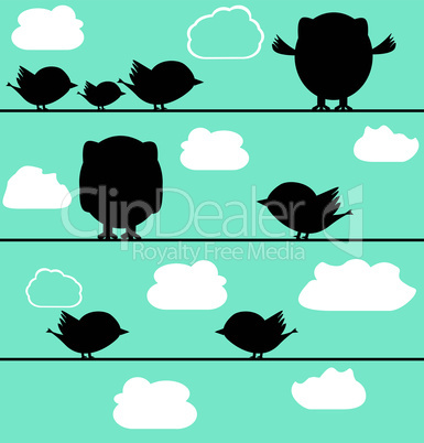 Silhouette of birds owl on a wire with clouds