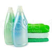 Fabric softener in two bottles and towels