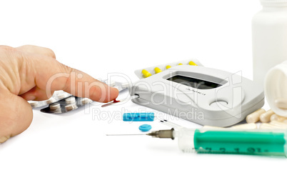 Glucometer with a hand, drugs and a syringe