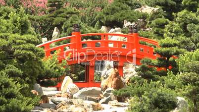 Red Wooden Arch Bridge and Little Waterfall