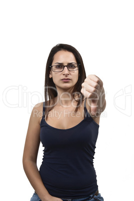 Young unhappy female shows thumbs down gesture isolated on white