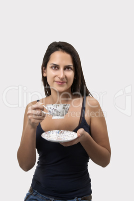 Lovely young woman with cup coffee isolated on white background