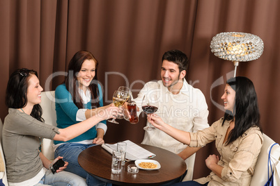 Happy friends enjoy drink at bar
