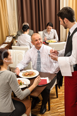 Business lunch waiter taking order at restaurant