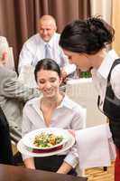Business lunch restaurant waitress serving woman